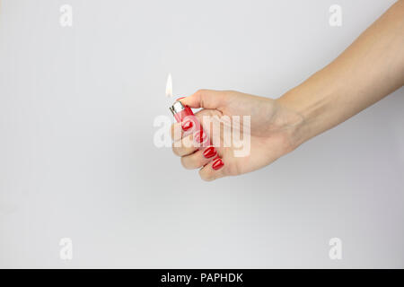 lighter with fire in woman's hand isolated on white background Stock Photo