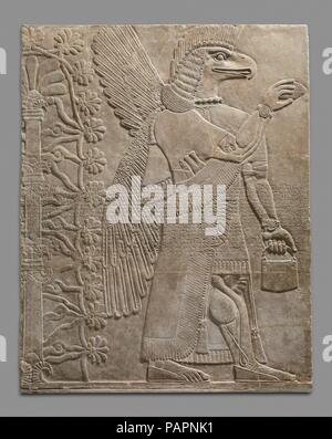 Relief panel. Culture: Assyrian. Dimensions: 90 1/2 x 73 5/8 x 2 1/4 in. (229.9 x 187 x 5.7 cm). Date: ca. 883-859 B.C..  This panel from the Northwest Palace at Nimrud (ancient Kalhu) depicts a winged supernatural figure. Such figures appear throughout the palace, sometimes flanking either the figure of the Assyrian king or a stylized 'sacred tree.' The reliefs were painted, but today almost none of the original pigment survives. However, the reliefs themselves retain incredible detail, including intricate incised designs on many of the figures' clothing.  The figure depicted on the panel is  Stock Photo