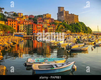 Boats of Lerici docked in Lerici port and famous Italian Gulf of Poets. San Giorgio castle on the background at sunset. La Spezia province, Ligurian Coast of Italy. Stock Photo