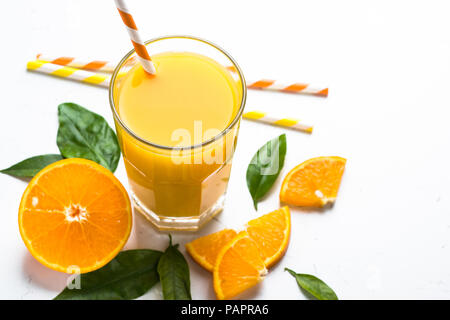 Fresh Orange juice smoothie in glass and sliced citrus around. Healthy drink on white. Stock Photo