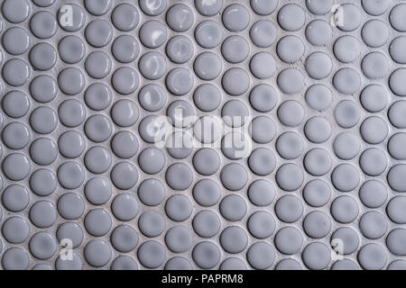 White ceramic tile wall with many small round unique pattern. Top view of bathroom wall tile is a round button tile. Circle white mosaic tile abstract Stock Photo
