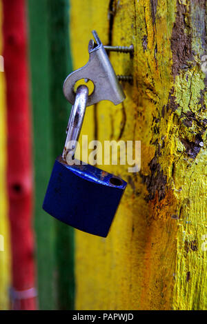 Old blue padlock on rustic wooden door Stock Photo