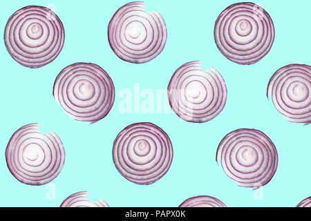 Top view pattern of fresh bright red onion rings on turquoise blue background. Shot from above of multiple sliced onions Stock Photo