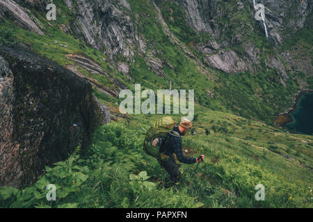 Norway, Lofoten, Moskenesoy, Man hiking downhill Stock Photo