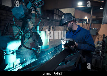 Welder welding metal with robot Stock Photo