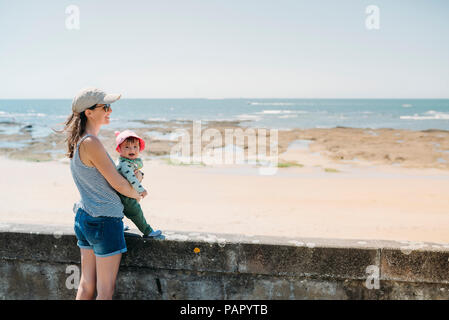 France, mother and baby at beach promenade Stock Photo