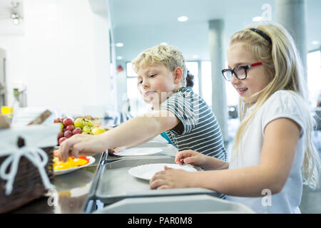 Pupils at counter in school canteen Stock Photo