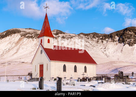 A traditional icelandic church stands proud at the foot of a small mountain, in southern Iceland. Stock Photo