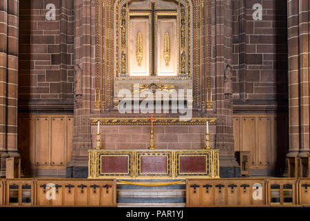 Candle sticks and crucifix on a side alter at Liverpool Anglican Cathedral is protected by a yellow rope Stock Photo