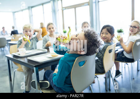 Pupils having lunch in school canteen Stock Photo