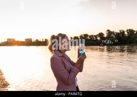 Blond woman and soap bubble Stock Photo