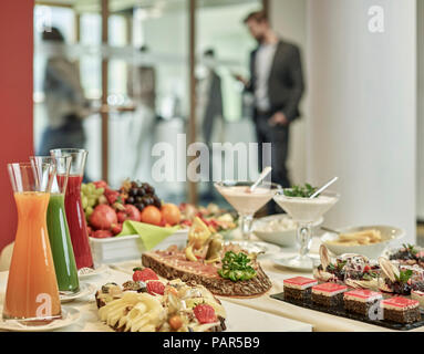 Buffet with appetizers and business people in background Stock Photo