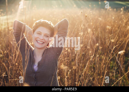 Portrait of laughing woman relaxing in nature Stock Photo