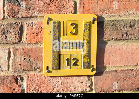 Fire Hydrant Sign on wall - the sign indicates the location of the nearest fire hydrant for use in emergency situations Stock Photo