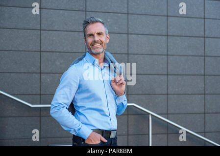 Portrait of content businessman wearing light blue shirt Stock Photo