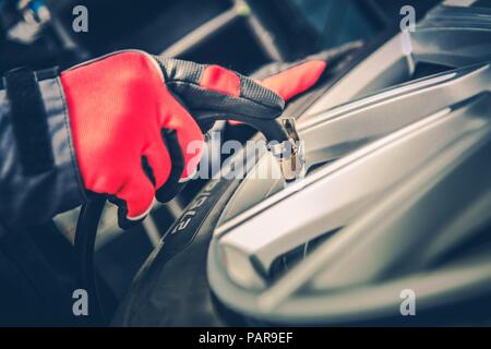 Tire Air Pressure Adjustment. Car Tires Maintenance. Closeup Photo. Stock Photo