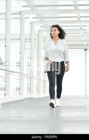 Young woman, goes through glass tunnel, Germany Stock Photo