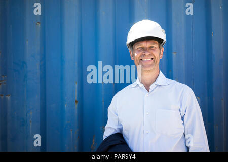 Portrait of smiling man wearing shirt and hard hat Stock Photo