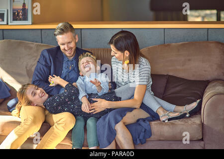 Happy family relaxing on the couch at home Stock Photo