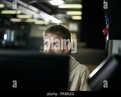 Man working, looking on screen Stock Photo