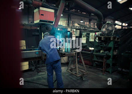 Welder welding metal in a factory Stock Photo