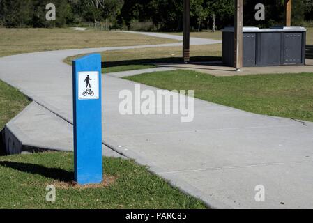 Sign post at shared path for bicycles and people walking at park in Australia. Pedestrian and bike path at public park. Stock Photo