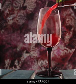 Red Wine Pouring into Tinted Glass Stock Photo