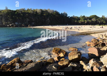 Shelly Beach and Cabbage Tree Bay Aquatic Reserve at Manly with sand and Tasman Sea. People relaxing on sandy Shelly beach at Manly. Stock Photo