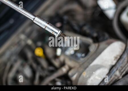 Mechanic changing broken car spark plugs. Car repair. Replacement of spark plugs Stock Photo