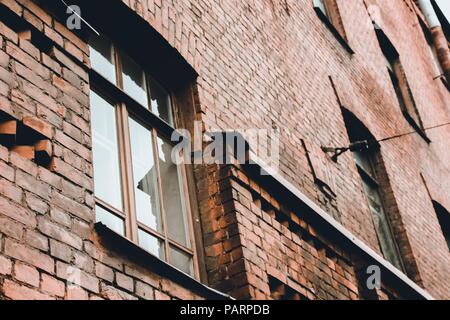 Large windows in an old brick building. The building was built in the nineteenth century, it was in these houses that the loft style originated. Stock Photo