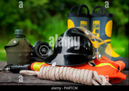 Outfit of Firefighter placed on wooden table background, Fire equipment concept. Stock Photo