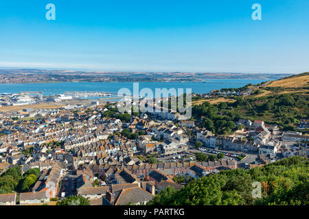 Portland Dorset England July 24, 2018 View from Portland Heights overlooking the town of Fortune's Well, showing Chesil Beach, Portland harbour and Th Stock Photo