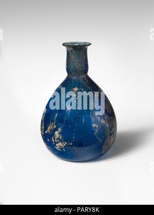 Glass perfume bottle. Culture: Roman. Dimensions: H.: 3 1/4 in. (8.3 cm). Date: first half of 1st century A.D..  Translucent cobalt blue.  Outsplayed rim, with fire-rounded lip; cylindrical neck, with horizontal tooled indent around base; piriform body; flat bottom, slightly concave at center.  Intact; some bubbles and blowing striations; patches of dulling, creamy weathering, and iridescence. Museum: Metropolitan Museum of Art, New York, USA. Stock Photo