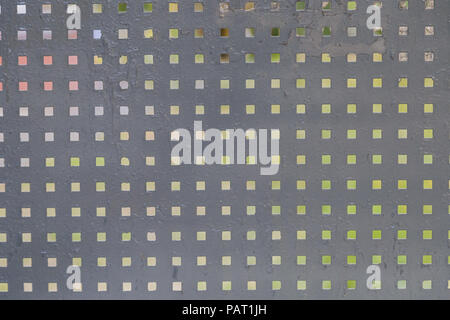 Iron background with square holes, metal texture. Stock Photo