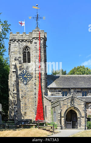 Remembrance end of First World War red poppy cascade made by local school children falls from top St Andrews Church clock tower Kildwick Yorkshire uk Stock Photo