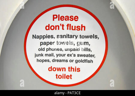 Public transport humour onboard passenger train toilet seat lid humourous instructions items not to flush down loo lavatory pan WC London England UK Stock Photo