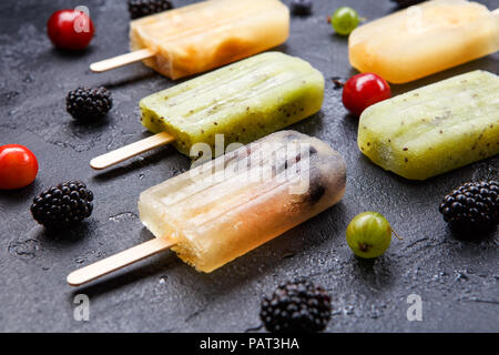 Photo on top of ice cream on stick, blackberry,cherry, gooseberry Stock Photo