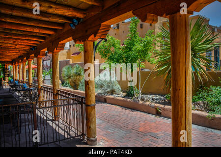 A Southwest style complex with beautiful hand hewn beams, posts and vigas with shopping, retail and restaurants nearby in old town Albuquerque, NM, Stock Photo