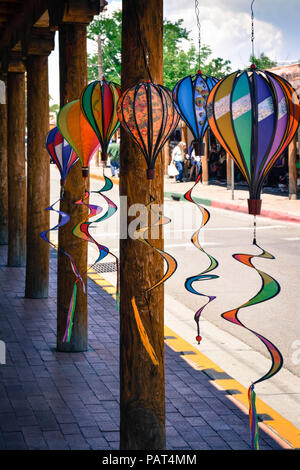 Handcrafted art of hot air balloons hang from under portico of Souvenir shop in of Old Town Albuquerque, NM Stock Photo