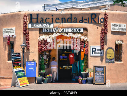 A colorful Entrance to old adobe building, the Hacienda del Rio, an Native American gift shop and restuarant with chili ristas welcoming tourists in o Stock Photo