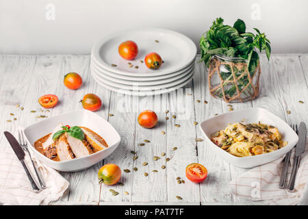 Delicious appetizers on a white table. Kind of assortment of delicious breakfast, free space on a white wooden background. Restaurant menu, banquet pr Stock Photo