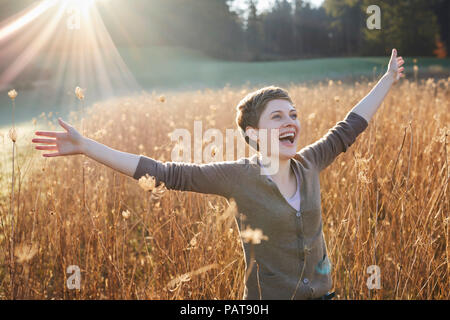 Portrait of laughing woman relaxing in nature Stock Photo