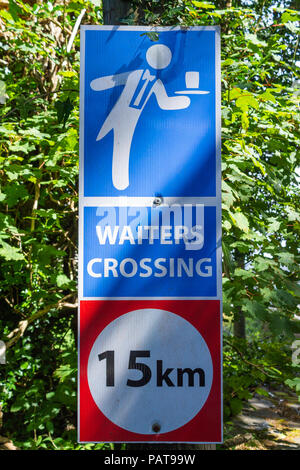 roadside or road side sign warning motorists of a traffic hazard of waiters on the road. Stock Photo