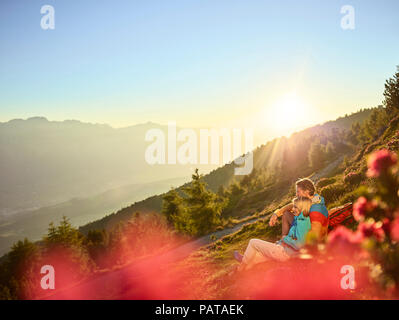 Austria, Tyrol, Couple hiking the Zirbenweg at the Patscherkofel, taking a break Stock Photo