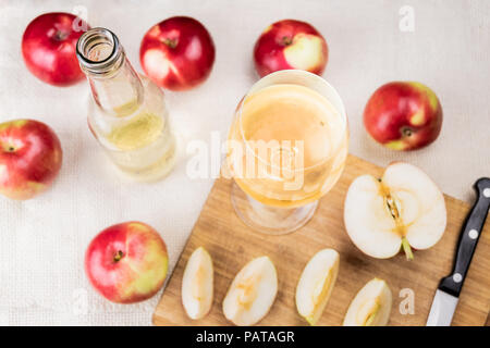 Flat lay with glass of cidre drink on rustic wooden table. Top view of home made cider and locally grown organic apples Stock Photo