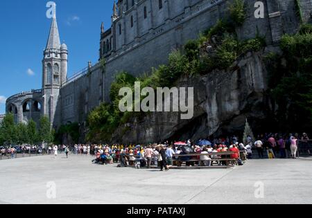 Pilgrims praying at the grotto in Lourdes,  Hautes  Pyrenees, France Stock Photo