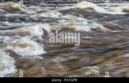 abstract shot of water rapids with foaming and violent water Stock Photo