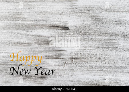 happy new year written in gold and black on antique rustic white grey wooden painted background copy space Stock Photo