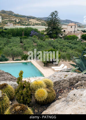 The pool and gardens at Azienda Agricola Mandranova, an agriturismo hotel and working olive farm outside of Agrigento in southern Sicily, Italy. Stock Photo