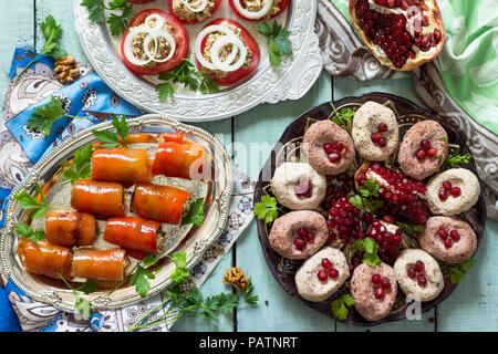 Bowl with delicious hummus, bread and tomatoes on wooden background ...